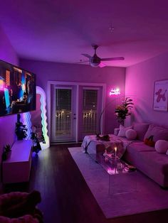 a living room filled with furniture and purple lighting