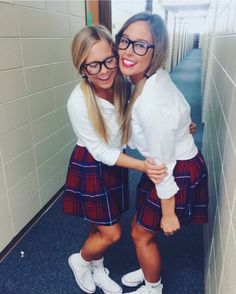 two girls in school uniforms hugging each other