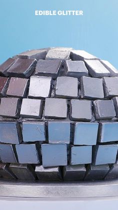 a close up of a cake on a plate with blue and gray tiles in the middle