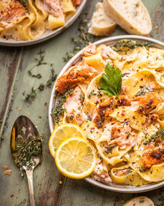 Salmon pasta on a plate with lemon and a spoon next to the plate with fresh thyme Autumn Pasta Recipes, Creamy Salmon Pasta, Salmon Pasta Recipes, Butter Poached Lobster, Creamy Salmon, Fall Pasta, Lemon Chicken Pasta, Creamy Macaroni And Cheese, Frozen Salmon