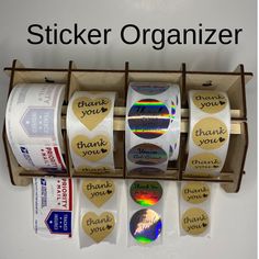 several rolls of stickers in a box with the words sticker organizer on them