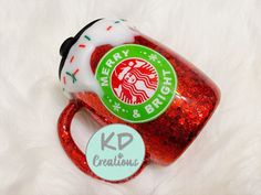 a starbucks cup with red and green sprinkles next to a white background