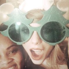 two women wearing green goggles and smiling for the camera