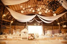 the inside of a barn decorated for a wedding