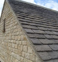 a close up view of the roof of a building that has a stone pattern on it