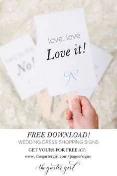 a person holding up a sign with the words love it and free wedding dress shopping signs