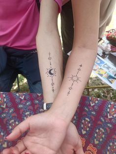 two people with matching tattoos on their arms