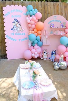 an outdoor party with balloons and decorations