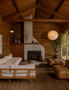 a living room filled with furniture and a fire place in the middle of a room