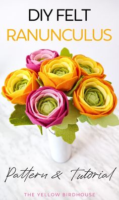 a white vase filled with colorful flowers on top of a wooden table next to text that reads, diy felt ranunculas