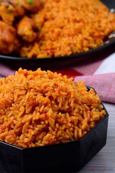 two black plates filled with rice on top of a table