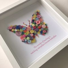 a white frame with buttons in the shape of a butterfly