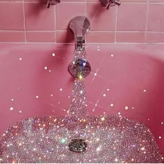 a pink bathtub filled with lots of glitter