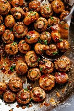 a pan filled with cooked mushrooms on top of a table