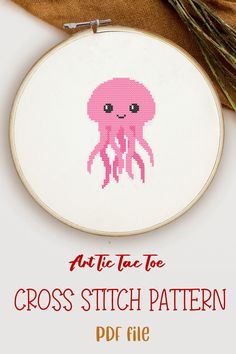 the cross stitch pattern has an image of a pink jellyfish on it's face