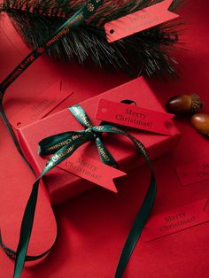 two christmas presents wrapped in red paper with green ribbon