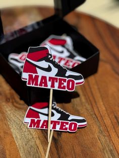 a pair of shoes on top of a wooden table next to a box with matches