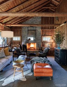 a living room filled with furniture and a fire place in the middle of it's walls