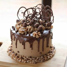 a cake with chocolate icing and nuts on top