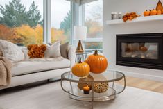 a living room filled with furniture and a fire place in front of a large window