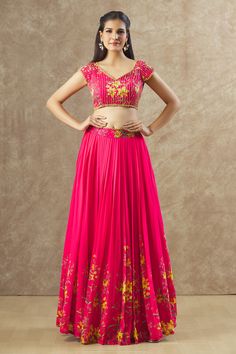 Reddish pink chinon silk lehenga with an attached cancan, floral print and sequins and beaded hand embroidered waistband. Comes with a padded blouse.
Components: 2
Pattern: Printed, Hand embroidered
Type Of Work: Floral, Sequins, Beads
Neckline: V Neck
Sleeve Type: Short
Fabric: Georgette
Color: Red, Pink
Other Details: 
Attached lining
Lehenga length : 45 inches
Approx Product Weight : 2 Kgs
Closure :
Lehenga : Side zip
Blouse : Back hooks and Drawstrings
Occasion: Sangeet - Aza Fashions Pink Bollywood Skirt Set With Zari Work, Pink Saree Skirt Set For Diwali, Pink Skirt Set With Saree Shape For Festive Occasions, Festive Pink Skirt Set With Unstitched Blouse, Bollywood Pink Skirt Set With Zari Work, Pink Fitted Skirt Set With Zari Work, Pink Skirt Set For Festive Reception, Festive Pink Skirt Set For Reception, Pink Fitted Zari Work Skirt Set