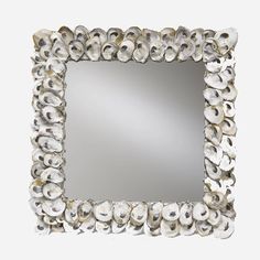 a mirror made out of shells on a white background