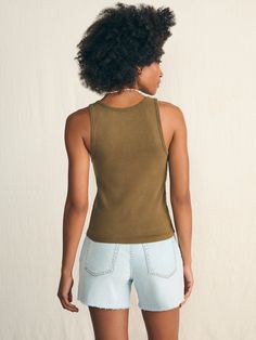 Look no further for the perfect summer tank top. Crafted in organic cotton that has been garment-washed for a lived-in look and feel, it fits like a dream – not too tight, not too loose. Cut in a flattering silhouette, this is the timeless wear-with-everything tank. Some call these basics – we definitely don't. Specifications Fit: Slim fit Detail: Sleeveless ribbed tank. Material: 95% Organic Cotton, 5% Elastane Model: Alissa is 5’9 wearing size Small Care: Turn inside out. Machine Wash cold with like colors. Gentle cycle. Do not bleach. Tumble dry low. Remove promptly. Cool iron when needed. Relaxed Washed Tops For Summer, Summer Organic Cotton Washed Tops, Relaxed Sleeveless Tank Top For Everyday, Organic Cotton Sleeveless Tank Top For Summer, Relaxed Spring Tank Top For Everyday, Everyday Organic Cotton Tank Top For Summer, Relaxed Muscle Tee For Everyday Summer Wear, Summer Everyday Washed Tops, Everyday Relaxed Muscle Tee For Summer