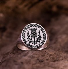 Embrace Scotland's rich heritage with our Scottish Thistle Ring, a timeless symbol of courage and resilience. Crafted with great attention to detail, this ring pays tribute to the Flower of Scotland and its enduring significance. Whether for oneself, the Scottish Signet Ring and the Scottish Flower Pinkish Ring capture the essence of Scottish pride and tradition. Each piece is a perfect celebration of strength and unity for everyone who holds Scotland close to their heart. Discover the beauty of Nature-inspired Engraved Ring As A Gift, Nature-inspired Engraved Ring For Gifts, Nature-inspired Engraved Round Ring For Gift, Scottish Ring, Signet Ring Women, Scottish Flowers, Flower Of Scotland, Scottish Pride, Thistle Ring