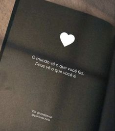 an open book with a white heart on it