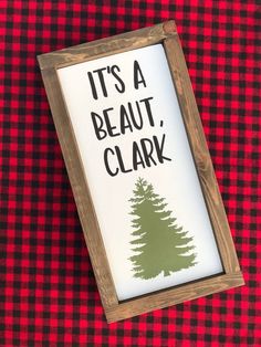 it's a beautiful, clark christmas sign on a red and black checkered tablecloth