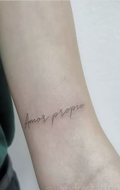 a woman's arm with an inscription on it that says, amer propo