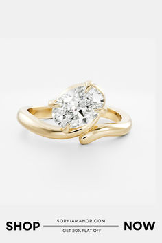 a yellow gold ring with two pear shaped diamonds on it and the words shop now