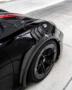 the rear end of a black sports car