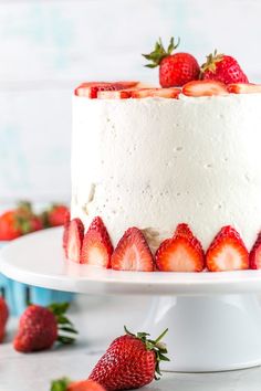 a cake with white frosting and strawberries on top