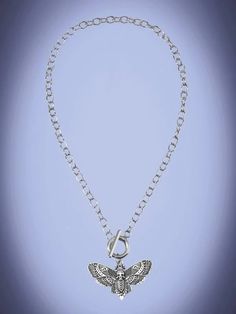 Introducing our Silver Goth Moth Charm Necklace, a captivating piece that beautifully combines elegance and mystique. Crafted with meticulous attention to detail, this enchanting necklace showcases the delicate charm of a moth in stunning silver. The pendant of the necklace portrays a gracefully poised moth, its wings expertly fashioned with intricate patterns. Each delicate curve and vein is expertly rendered, capturing the ethereal beauty of this nocturnal creature. The silver craftsmanship br Gothic Sterling Silver Necklace With Lobster Clasp, Fantasy Metal Pendant Necklace, Metal Butterfly Pendant Necklace With Clavicle Chain, Silver Metal Necklace With Butterfly Charm, Silver Necklace With Butterfly Charm, Bohemian Necklace With Butterfly Charm, Gothic Pendant Necklaces With Chain, Gothic Pendant Necklace With Chain, Festival Butterfly Charm Necklaces