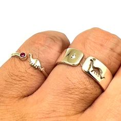 "Discover the Matching Dinosaur Ring with Your Personalized Birthstones. This promise ring is not for everyone but is only meaningful to special someone. Base Material: 925 Sterling Silver  Men Ring Depth: 7mm  Women's Ring Depth: 5mm Metal Stamped: 925 Stone: Cubic Zirconia Thickness: 1.5mm Themes: Dino Style: Couple Matching Ring Ring Size: We can make from US 4 - 14. We accept half-size. Please state after the order. SPECIAL ANNOUNCEMENT  1. Please visit https://www.etsy.com/shop/yhtanaff for Symbolic Adjustable Stackable Rings For Anniversary, Symbolic Adjustable Stackable Promise Rings, Nickel-free Adjustable Promise Rings, Adjustable Nickel-free Promise Ring, Adjustable Stackable Couple Rings For Promise, Unique Adjustable Birthstone Ring For Anniversary, Adjustable Symbolic Promise Rings, Adjustable Symbolic Stackable Rings As Gift, Adjustable Symbolic Stackable Rings For Gift