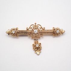 Antique 14k (.585) yellow gold ornate bar pin or brooch, decorated with Diamonds - approx. 0.39ctw, SI1-SI2 clarity, color I-J. This magnificent brooch is 2 3/8" long, 1 3/8" wide, weighing 10.2 grams. EA4806 Formal Yellow Gold Brooches With Single Cut Diamonds, Classic Diamond Yellow Gold Brooches, Classic Yellow Gold Diamond Brooches, Classic Yellow Gold Diamond Brooch, Elegant Gold Brooches With Diamond Accents, Yellow Gold Brooches With Single Cut Diamonds For Wedding, Gold Brooches With Diamond Accents For Formal Occasions, Formal Yellow Gold Brooch With Diamond Accents, Formal Yellow Gold Brooches With Diamond Accents