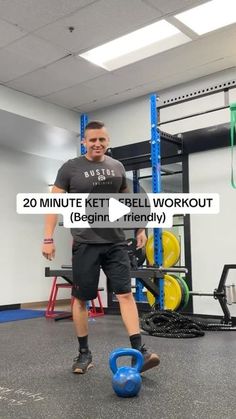 a man standing next to a blue ball in a gym with the words 20 minute kettlebell workout begin, friendly