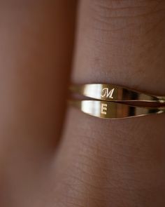 a woman's gold ring with the letter n on it