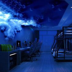 a room with bunk beds, desks and clouds painted on the wall above them