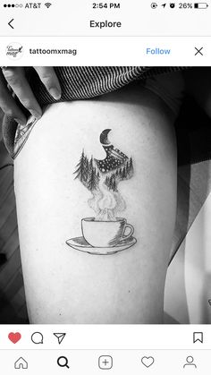 a black and white photo of a bird sitting on top of a coffee cup tattoo