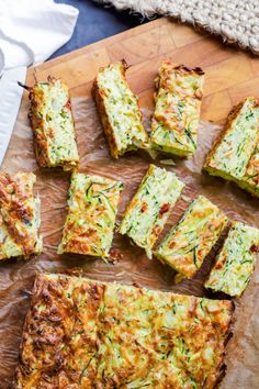 zucchini bread cut into squares and placed on a cutting board next to a knife