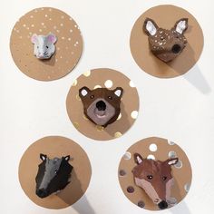 four different animal heads are placed on paper circles