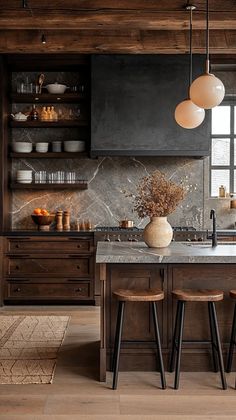 a kitchen with wooden cabinets and marble counter tops, two stools are in front of the island