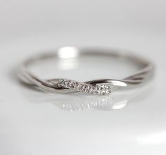 a white gold ring with three diamonds on it