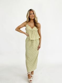 Indulge in the luxurious blend of texture and comfort with our Sage Garden Picnic Skirt. Featuring a soft, stretchy fabric, a high waist and midi fit for a chic and feminine look. With a gorgeous floral pattern, back slit detail, and adjustable drawstring waistband, this skirt is perfect for spring and summer occasions such as date nights and brunches. Style it to perfection and be the epitome of elegance, all while feeling incredibly comfortable. Self 95% Polyester 5% Spandex Lining 100% Polyes Picnic Skirt, Sage Garden, Garden Picnic, Feminine Look, Drawstring Waistband, Stretchy Fabric, Long Skirt, Date Night, Floral Pattern