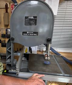 a man working on a machine in a shop