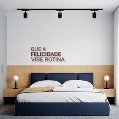 there is a bed with white sheets and blue headboard in the room that says que a felicidade vire rotina