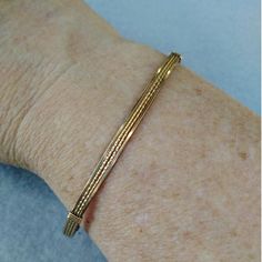 A pretty little bracelet of four strands of 14kt gold filled wire--two twist in the middle and two plain square on either side. So sweet and feminine! This one stacks nicely with a number of my other bangle-style bracelets! The sturdy built-in hook and eye clasp is easy to get on and off by yourself. Choose your size for a perfect custom fit! This design is also available in sterling silver and two-tone. Add on a jewelry polishing cloth to keep your bracelet--and ALL your jewelry--shiny clean! h Classic Friendship Bangle Bracelets, Classic Bangle Bracelets For Friendship, Classic Adjustable Braided Bangle Bracelet, Dainty Gold Bracelet, Adjustable And Flexible, Elegant Friendship Wrap Bracelet, Dainty Gold Bracelet Adjustable And Flexible, Elegant Gold Hand Wrapped Stretch Bracelet, Elegant Jubilee Cuff Bracelet For Friendship, Adjustable Flexible Chain Bangle Bracelet