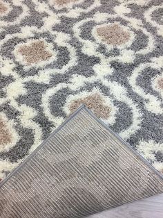 an area rug is laying on the floor next to a piece of carpet that has been cut in half